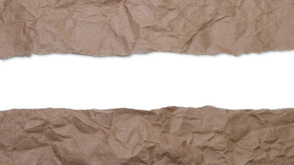 Fototapeta na wymiar Torn, crumpled brown wrapping paper revealing white copy space in center gap.