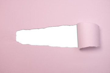Pink torn paper with hole in centre revealing white copy space