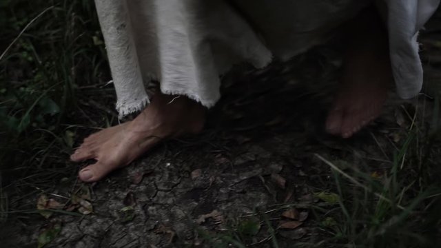 Closeup of Jesus feet walking in forest trees