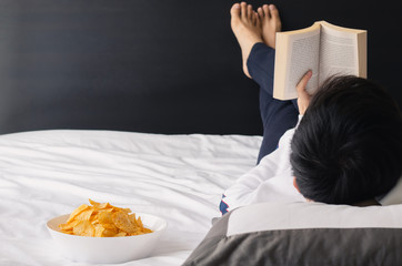 Potato Chips mixing with seaweed powder in white bowl put on bed for snack when reading book on bed. Stay home concept.