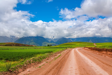 Fototapeta na wymiar Beautiful landscape of gravel road, fields, meadows and mountains in Peru, South America 
