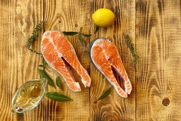 Two raw fresh salmon or trout steaks,  with lemon ant herb 