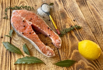 Delicious salmon steak, aromatic spices vegetables and lemon