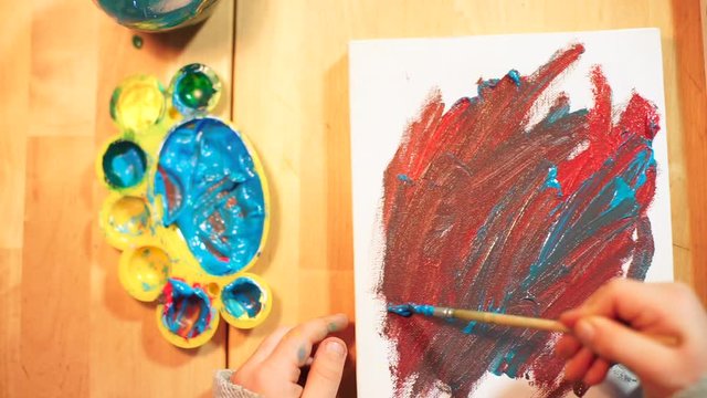 Abstraction is depicted in blue and brown colors on canvas. Kids can create amazing masterpiece paintings during home quarantine.   Home education COVID-19.