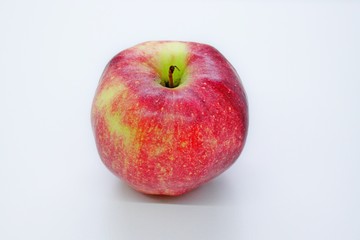 Beautiful red juicy apple located on a gray background