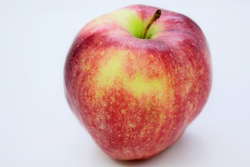 Beautiful red juicy apple located on a gray background