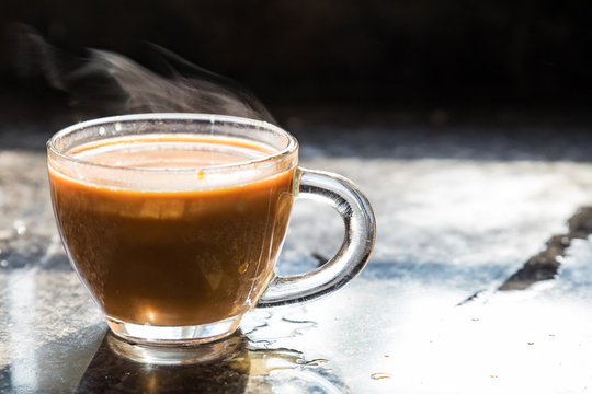 a close up of tea cup filled with hot steamy masala tea