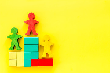 Winners podium. Figures of humans on yellow background top view copy space
