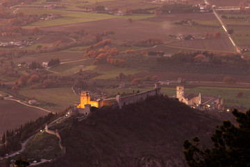 An epic view of St.Francis church and Rocca Maggiore in Assisi town (Umbria) above valley at sunset