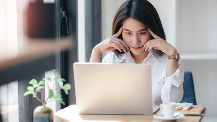 Young beautiful woman thinking about her job while working at home.