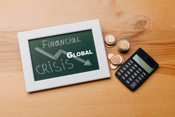 charts of economics and stock markets on a chalk board. financial crisis concept.