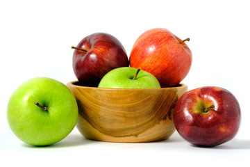 Group of green and red Apple fruit on a wooden bowl / basket isolated on white background