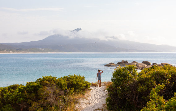 person in landscape looking across Bettys Beach to Mount Manypeaks
