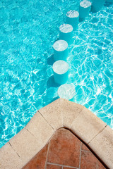 A Step in the pool by the sea nature background. For bathing turquoise water.