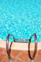 A Steps ladder to pool by the sea nature background. For bathing turquoise water.