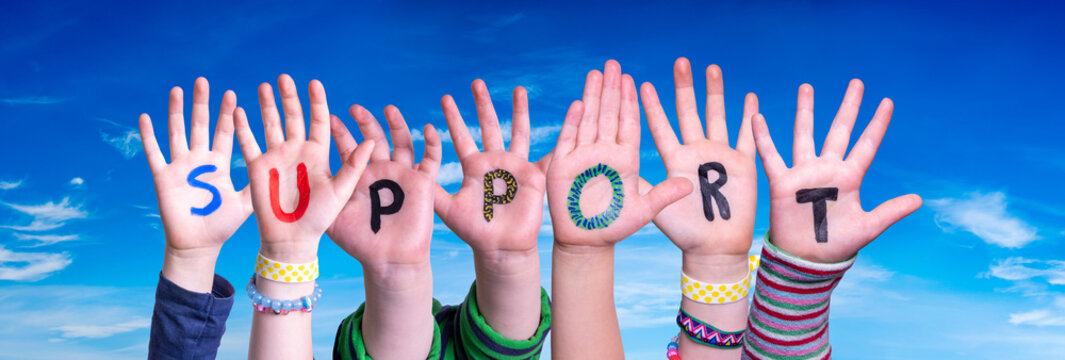 Children Hands Building Colorful English Word Support. Blue Sky As Background