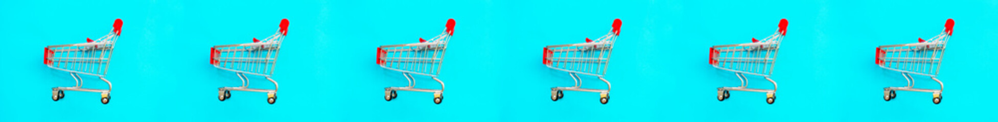 Basket on a blue background. Shopping cart in a supermarket. Sale, discount, shopaholism. Creative design. Banner.