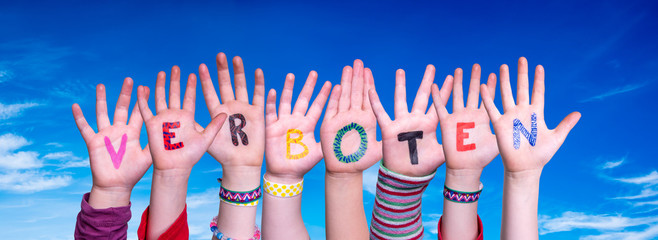 Children Hands Building Colorful German Word Verboten Means Forbidden. Blue Sky As Background