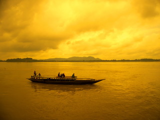 Naklejka na ściany i meble Boat sailing at river brahmaputra during sunset