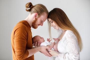 Parenthood, love and family concept - Smiling mother and father holding their baby son.Happy...