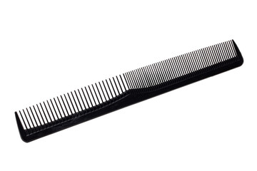 Hairdresser tools isolated. Close-up of a black hair comb isolated on a white background. Equipment of hair stylist. Macro photograph.
