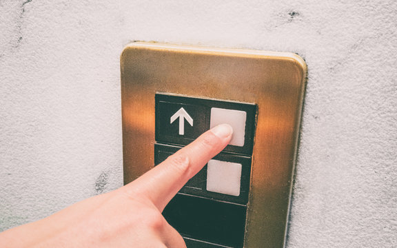 COVID-19 Hygiene Prevention. Pressing Elevator Button With Finger Touching Public Surface With Germs, Hand Care For Coronavirus Spreading In Community.