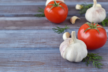 Appetizing tomato with garlic. A wooden table with vegetables.