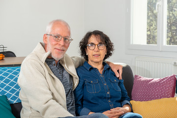 Senior couple relaxing on sofa at home