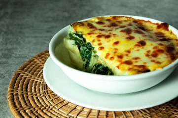 Spinach lasagna with cheese  in white plate, Italian food style , Vegetarian lasagna