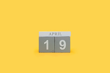 gray wooden cubes of perpetual calendar with the date of Easter April 19