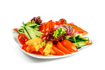 Sliced vegetables on a plate on a white background. Assorted fresh vegetables.