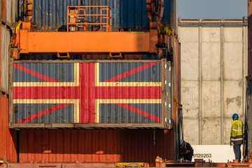 Unloading a container with the flag of Great Britain aboard a container ship