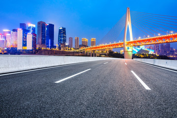 Fototapeta na wymiar Empty asphalt road and city skyline with buildings at night in Chongqing,China.