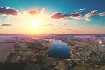 Naklejka premium Spring rural landscape in the evening, aerial view. Panoramic view of the river on the meadow at sunset. Panorama from 9 images