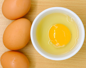 Close-up view of raw chicken eggs on background