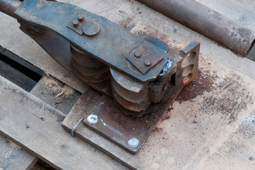 Old hand tool for bending pipe is fixed on a tree