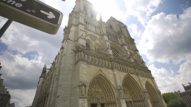 Notre Dame Cathedral push in past sign, Summer, daytime, Paris, France, 4K