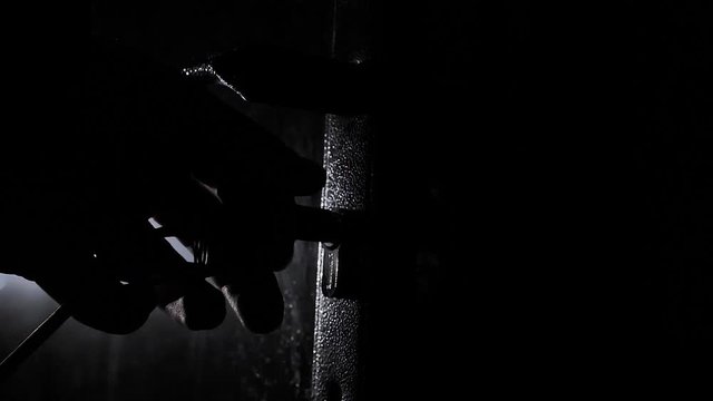 An Unrecognizable Person Opens a Keyhole With a Key and Opens the Door in a Dark Gloomy Hallway Criminal Burglary Concept