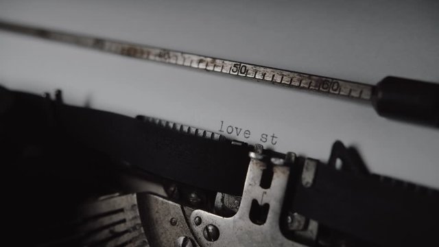 Typing "love story" on retro typewriter, 4K movie look