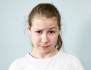 Confusion, misunderstanding on the face of a teenage girl, background, emotions series