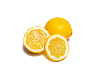 Lemons on white background. Pieces of lemons and whole lemons, with little shadow. Groups of yellow lemons on white