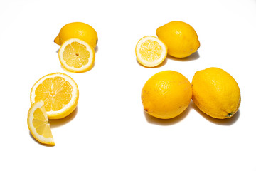 Lemons on white background. Pieces of lemons and whole lemons, with little shadow. Groups of yellow lemons on white