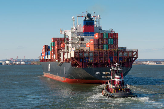 New York City, USA - November 18, 2011: Container ship APL Turquoise with an accompanying tug in New York Harbour at November 18, 2011, United States Of America. Flag: Singapore.