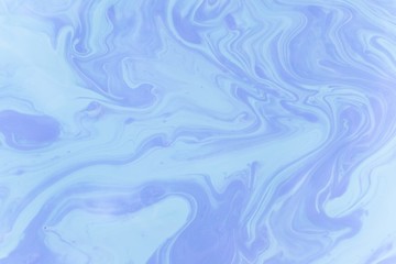 Abstract background of mixed shades of nail polish with a pastel marble pattern. Liquid colorful background paint creative pastel cold blue hue