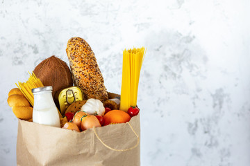 Full paper bag with healthy food.Healthy food background.Supermarket food concept.Milk, cheese,...