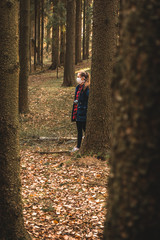 young woman with face mask in the woods