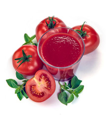 Fresh red tomatoes in basket and tomato juice in glass and jug on white