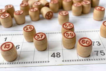 Board game lotto or bingo. Wooden lotto barrels on game cards. The concept of leisure at home in isolation with family. Interesting fun pastime