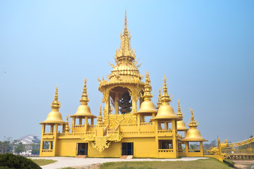 Unique Golden temple at the white temple and popular tourist attraction in Chiang Rai (known as Wat Rong Khun) in the North of Thailand