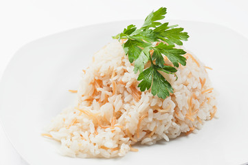 Boiled rice with parsley on a white plate. White background